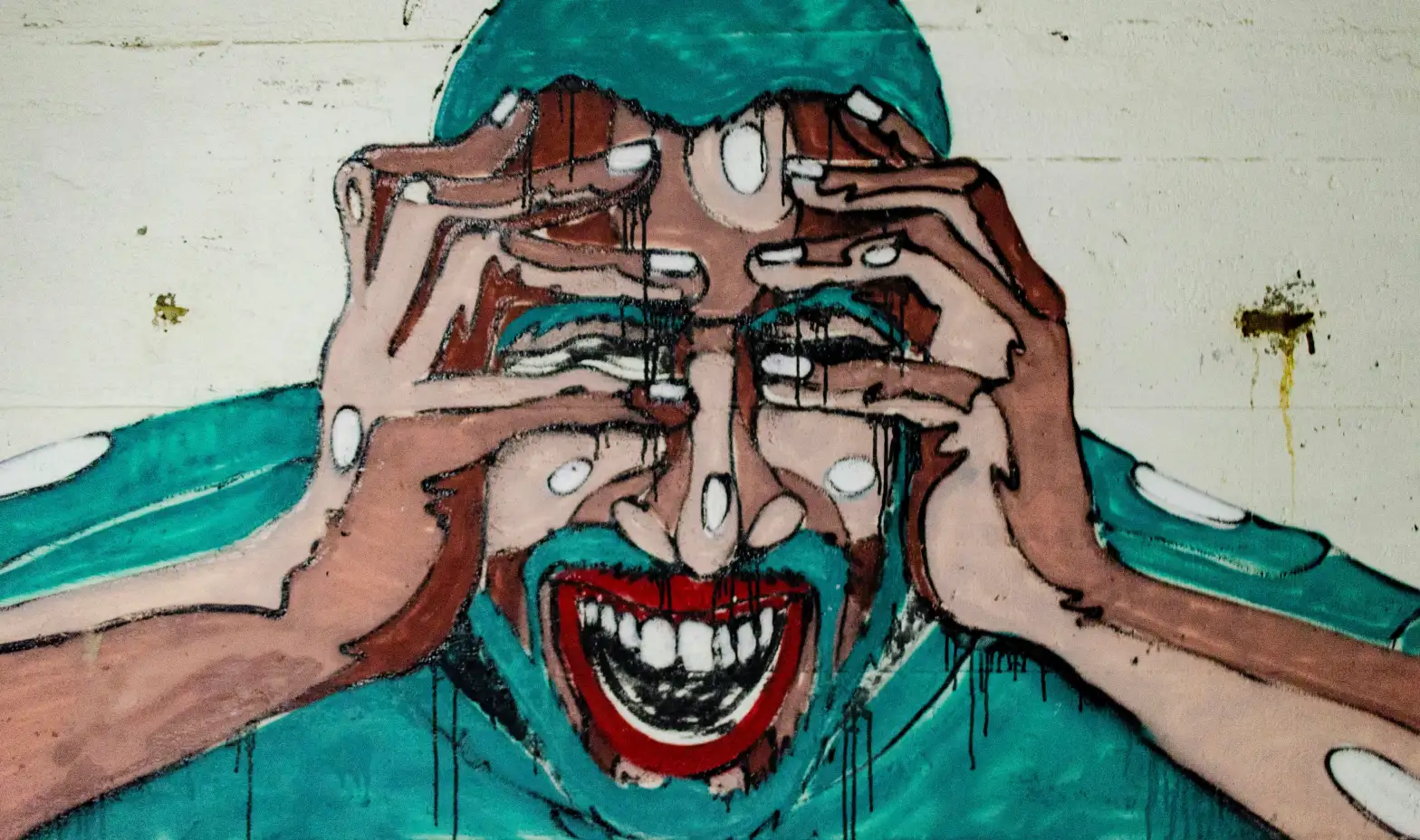 A man in a painting has his hands over his eyes, suggesting a moment of reflection or hiding from the world.