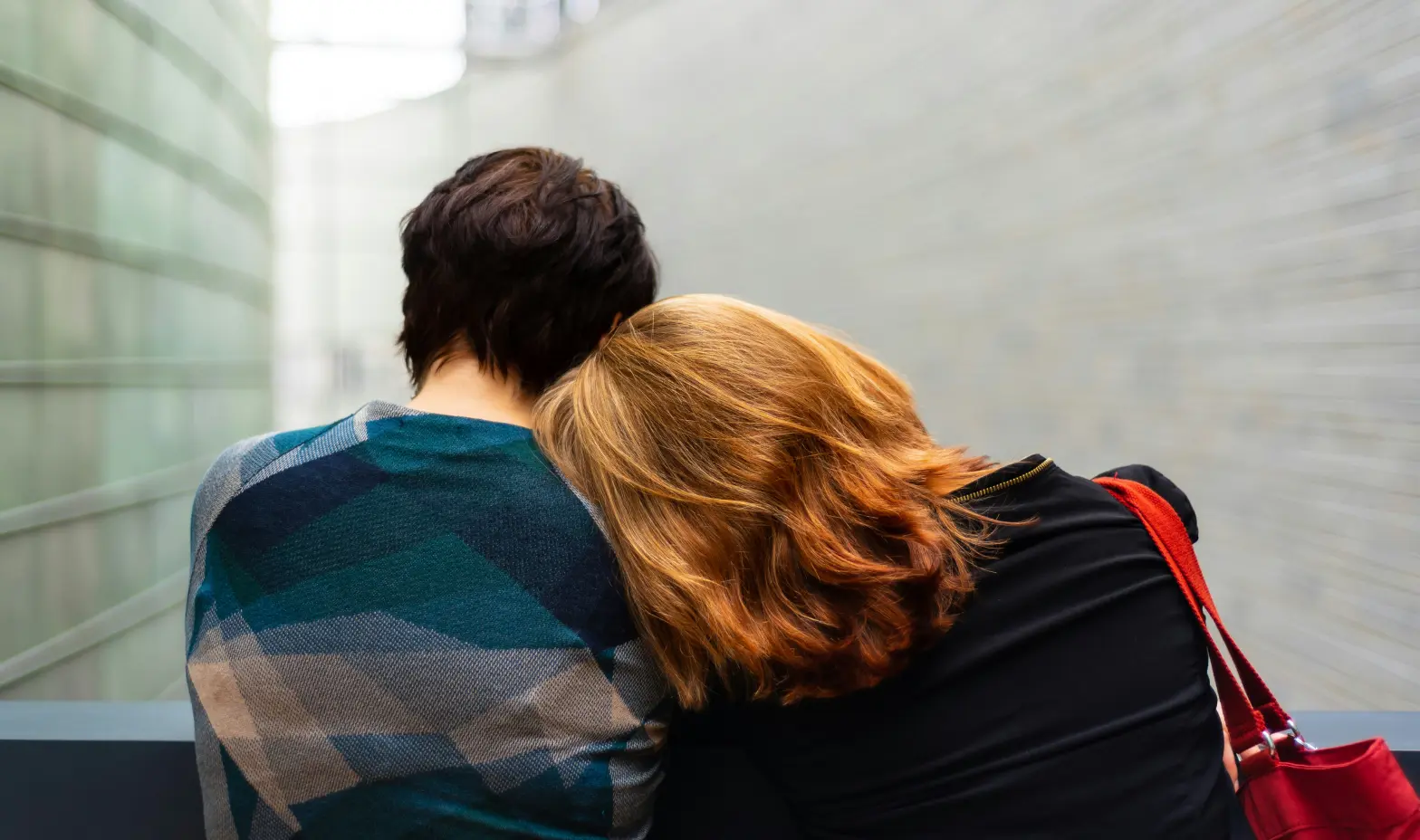 Two people sitting on a bench