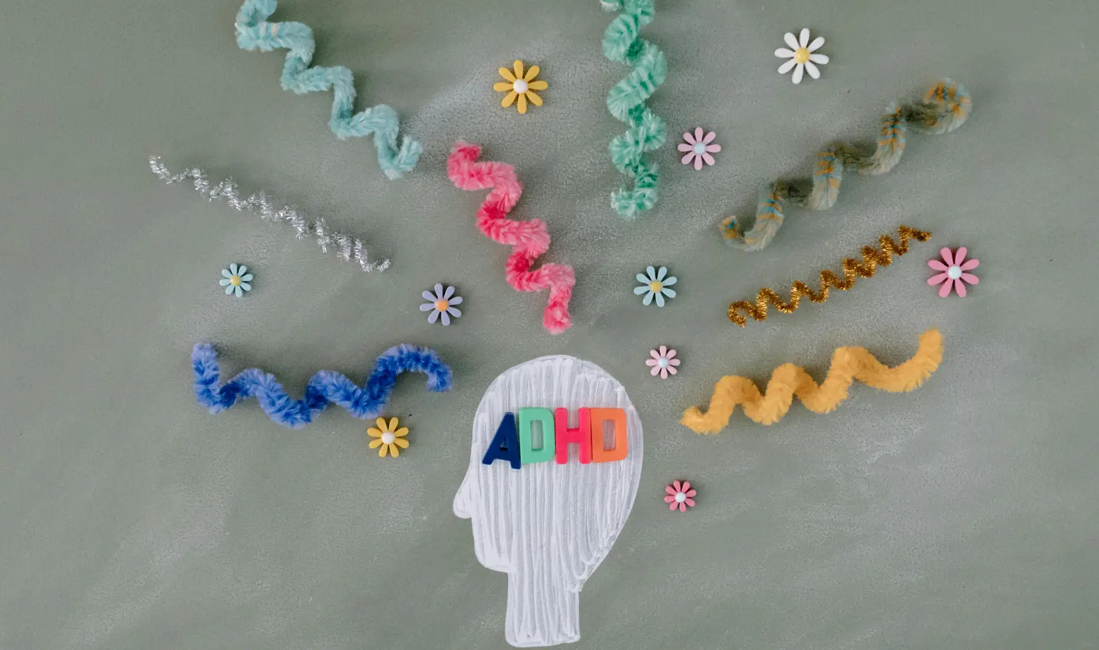 A head decorated with bright ribbons, encircled by a swirl of colorful ribbons.