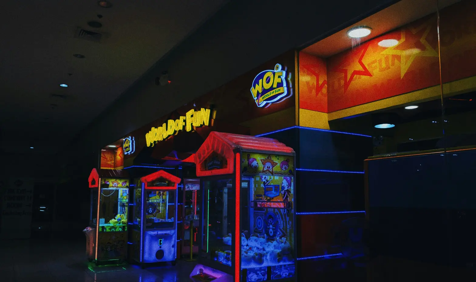 A line of arcade machines positioned inside a building.