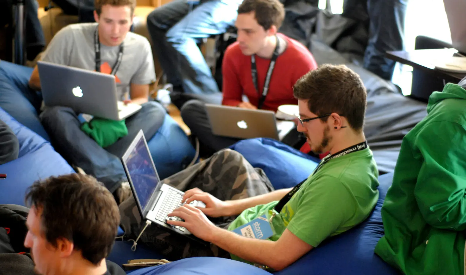 A diverse group of individuals sitting comfortably on bean bags.