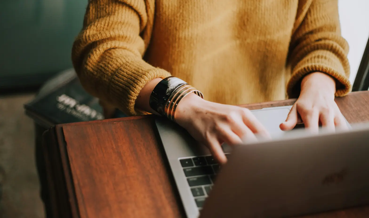 A woman typing on a laptop