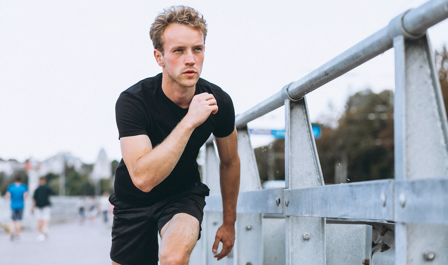 runner sprinting on a bridge