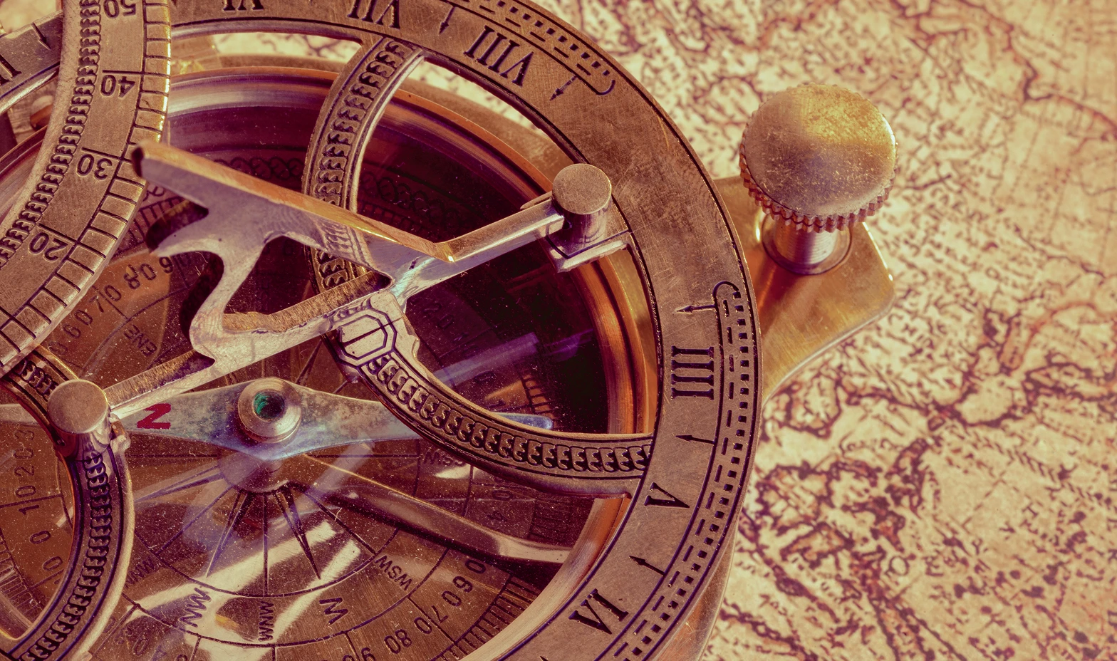 Old compass over ancient map