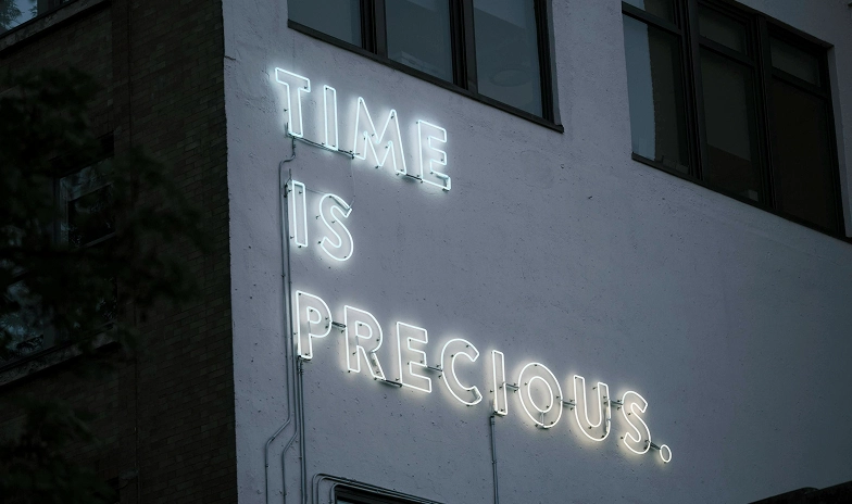 a neon sign that reads time is precious