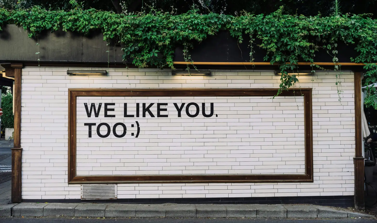 A cheerful billboard with the words "We like you too" prominently displayed."
